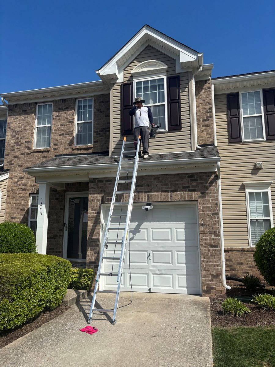 painter on ladder outside townhome Preview Image 2