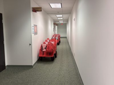 carpeted hallway with stroller buggies