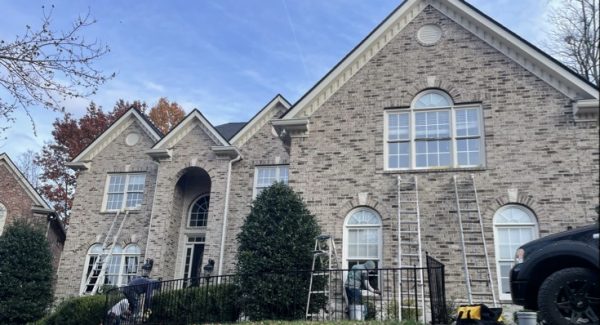 painters with ladders against outsdie of home