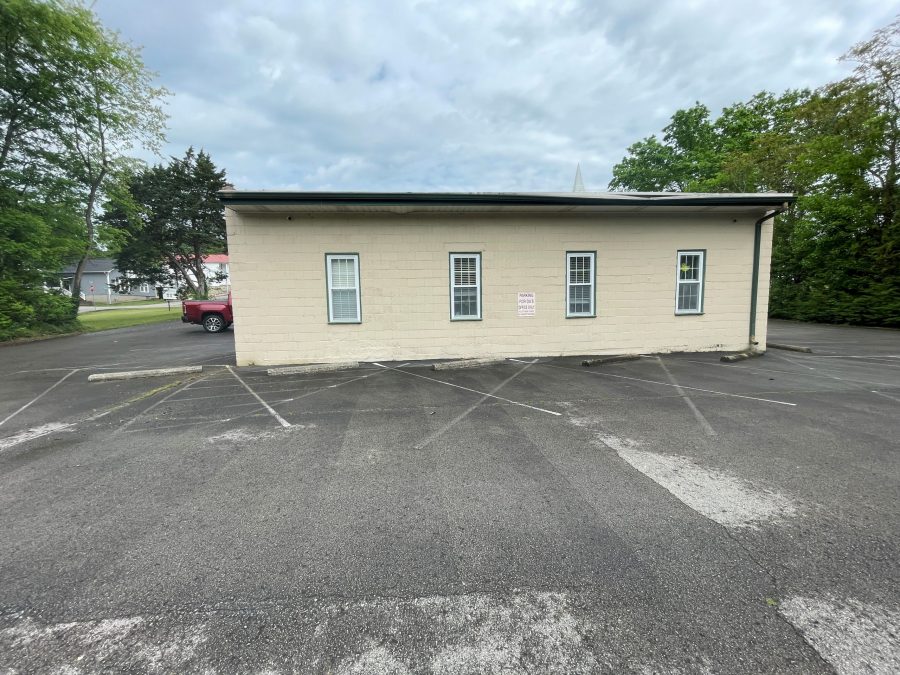 off-white and green commercial exterior before repaint Preview Image 11