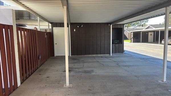 stained wood fencing surrounding covered parking area Preview Image 1