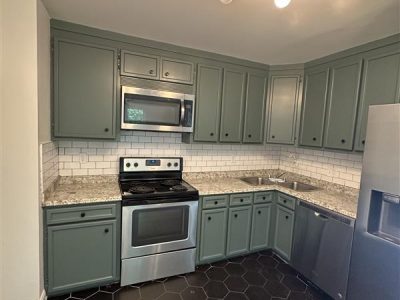 kitchen with green painted cabinets