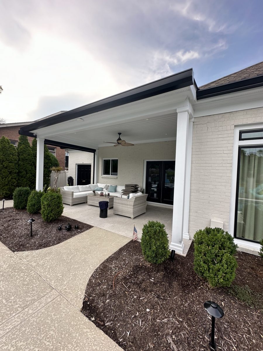 covered patio of white house with black painted trim Preview Image 3