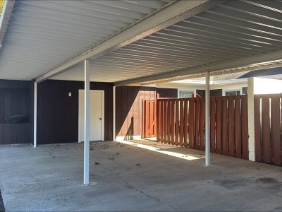 stained wood fencing surrounding covered parking area