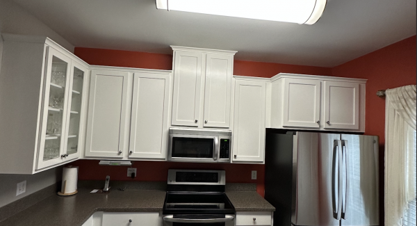 white cabinets with red interior wall paint