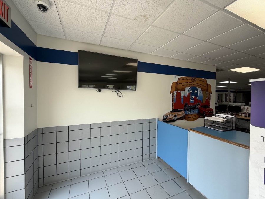 car dealership interior with blue stripe paint on upper wall Preview Image 2