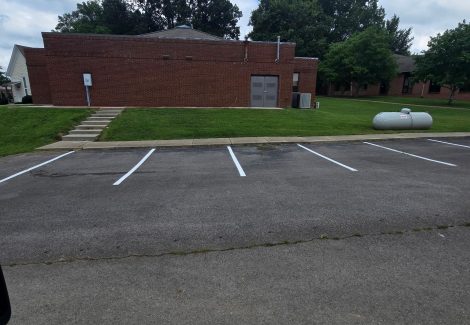 parking lot with repainted striping and space numbers