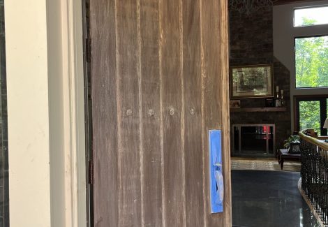 wooden front door with fading stain