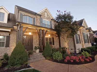 brick home with painted trim and shutters