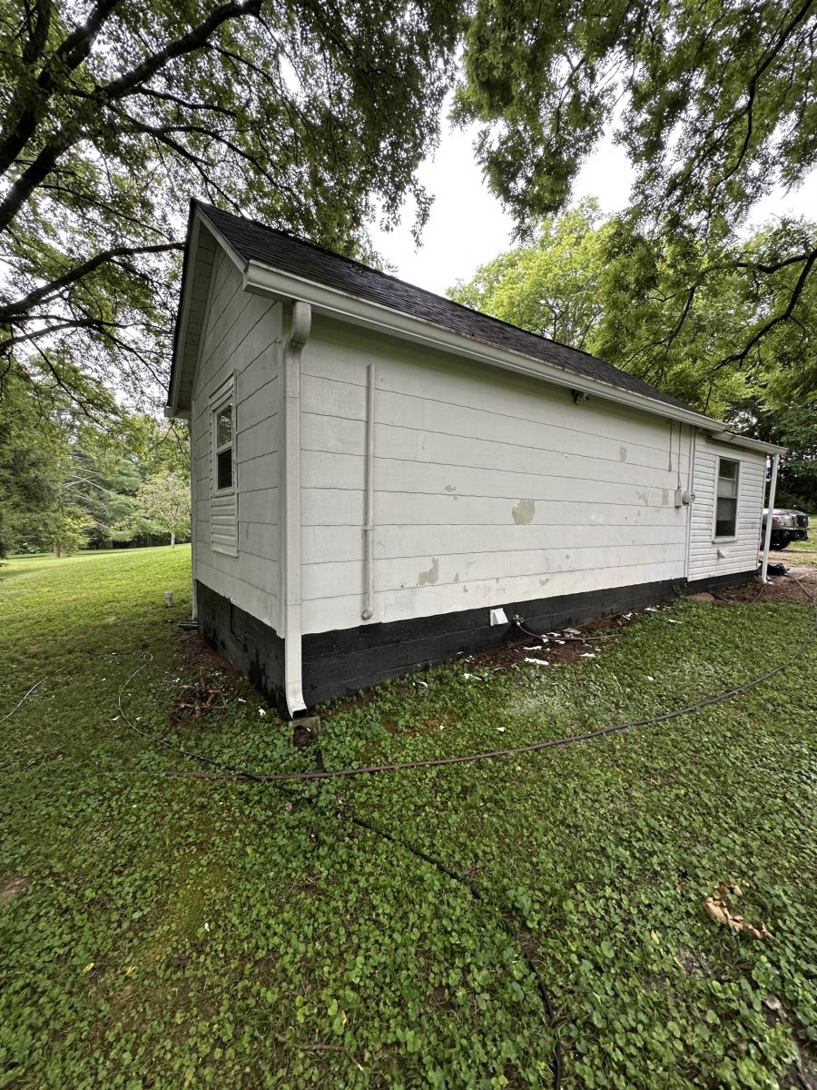 side of house with damaged white siding and black shutters Preview Image 18