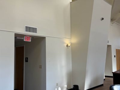 high-ceiling room with plain white walls