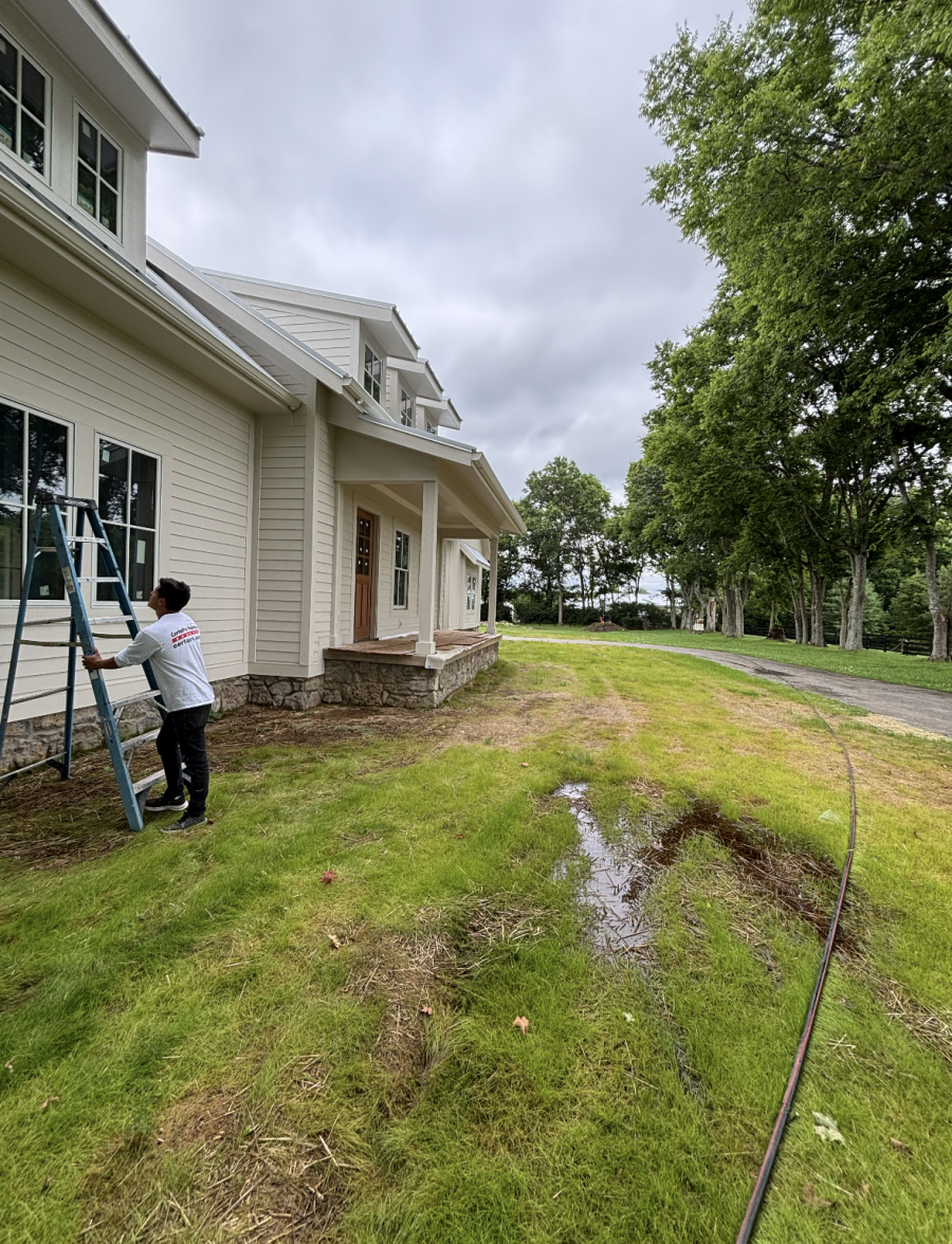 painters with ladders painting siding on house Preview Image 1