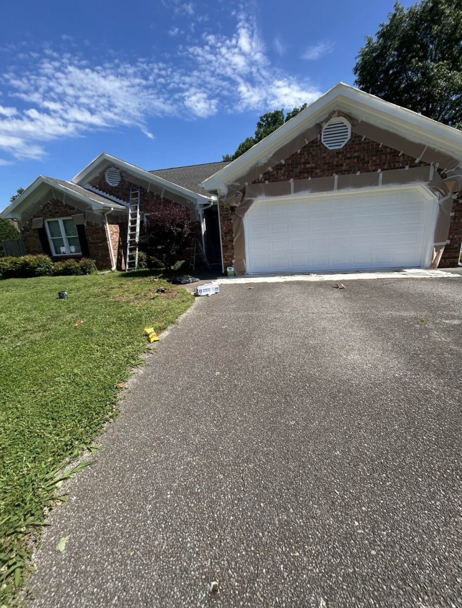 brick home in process of trim painting Preview Image 3