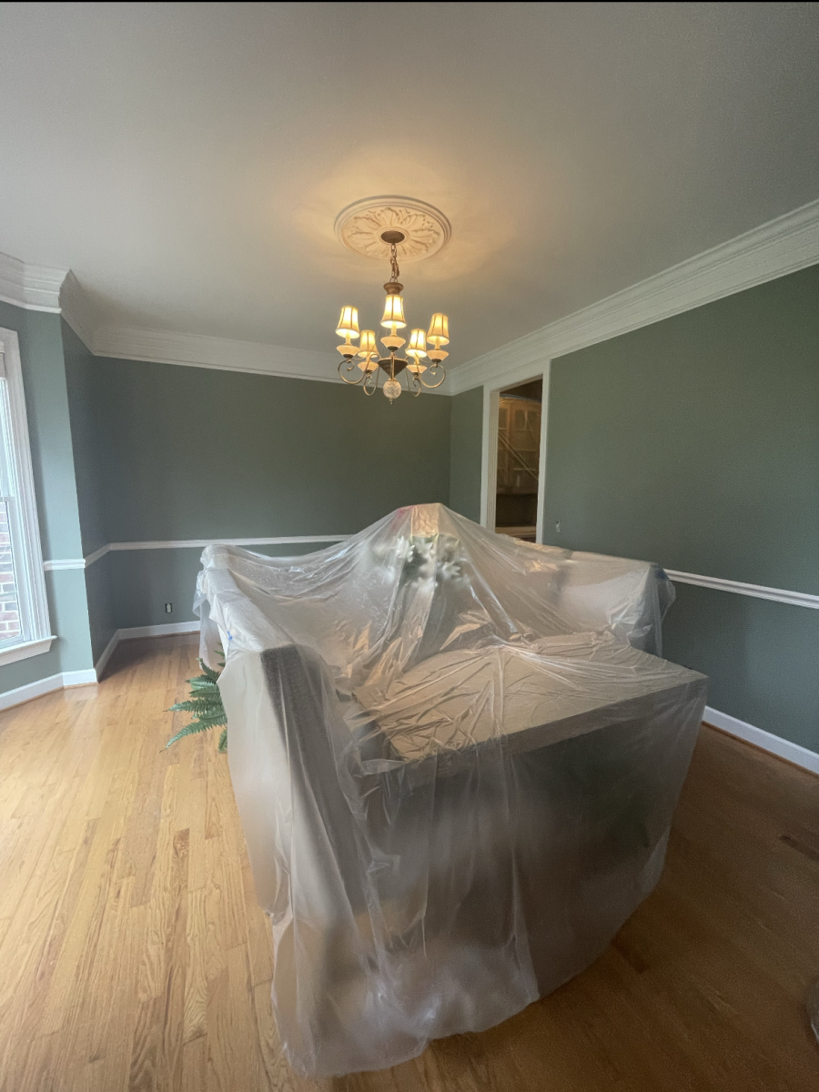 green dining room with white chair rail and trim and furniture covered in plastic Preview Image 1
