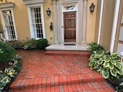 multi-family residential building entrance with power washed brick and marble