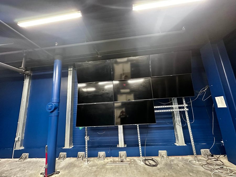 monitors mounted in blue painted industrial space interior room Preview Image 2