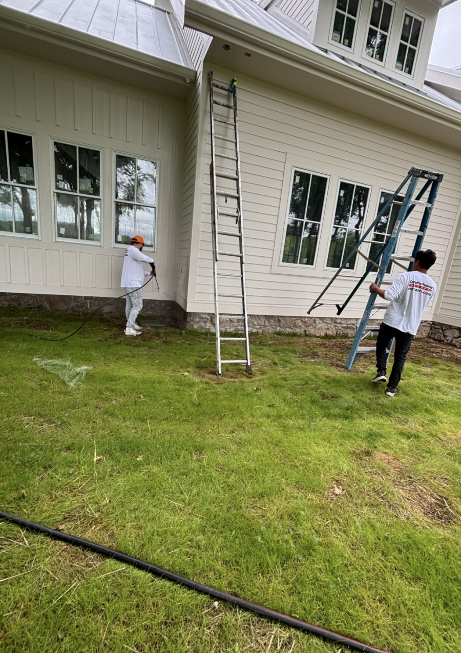 painters with ladders painting siding on house Preview Image 2