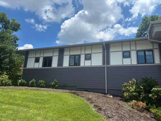 side of building with repainted grey and white siding