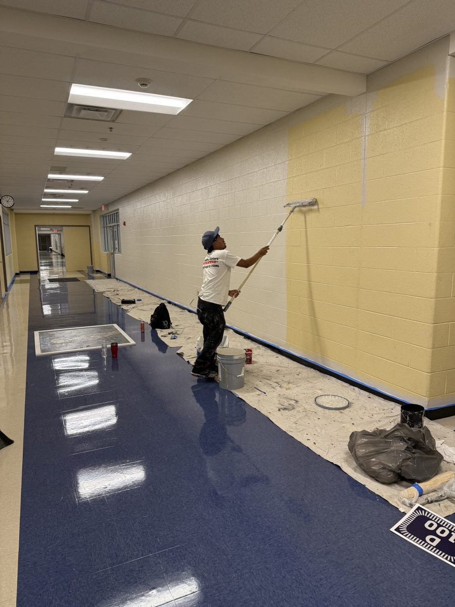 painters with rollers painting school hallway Preview Image 1