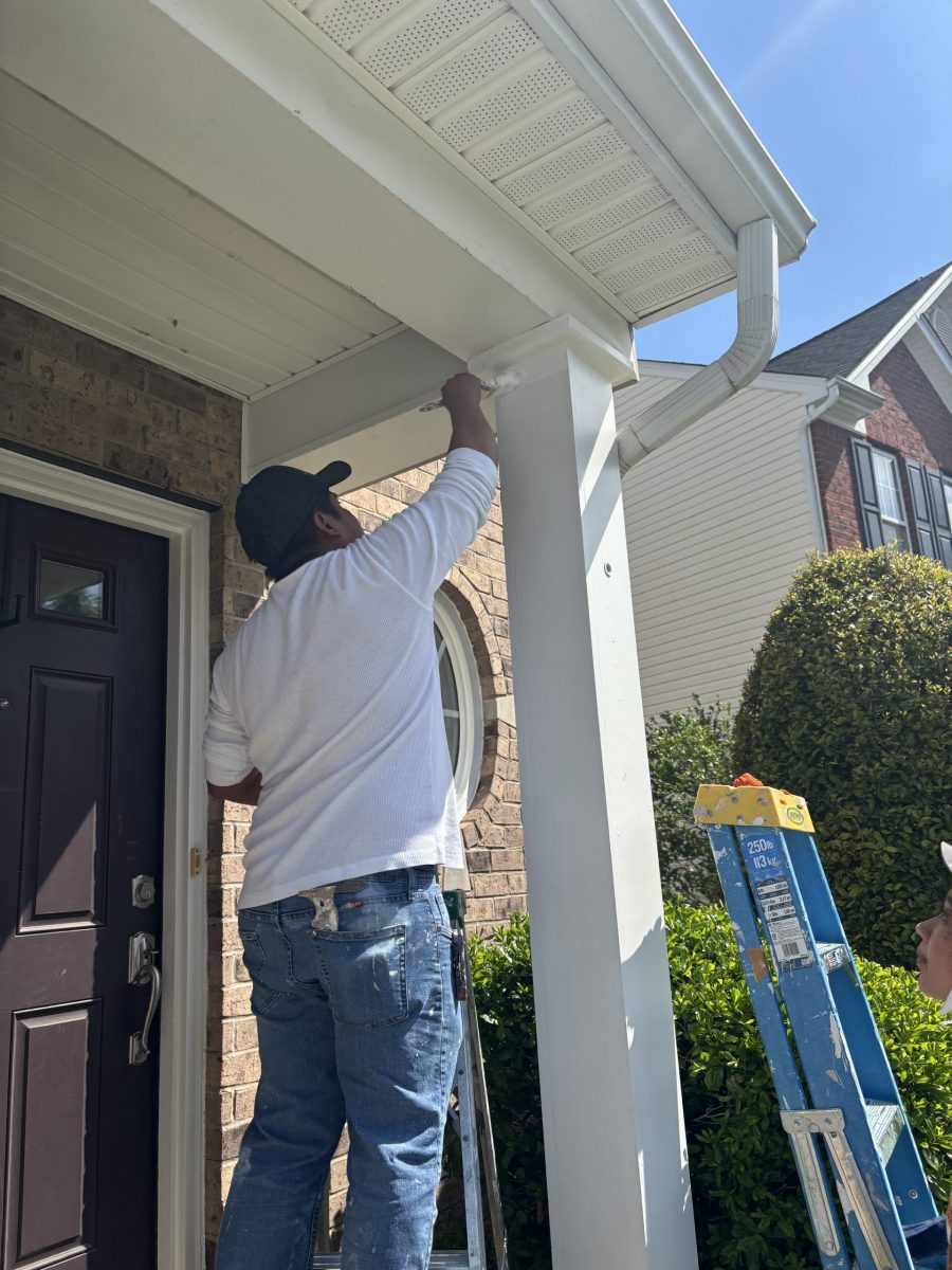 painter working on column outside house Preview Image 1