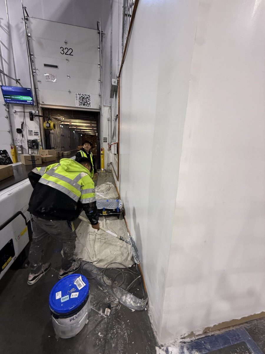 person painting drywall office walls within warehouse Preview Image 6