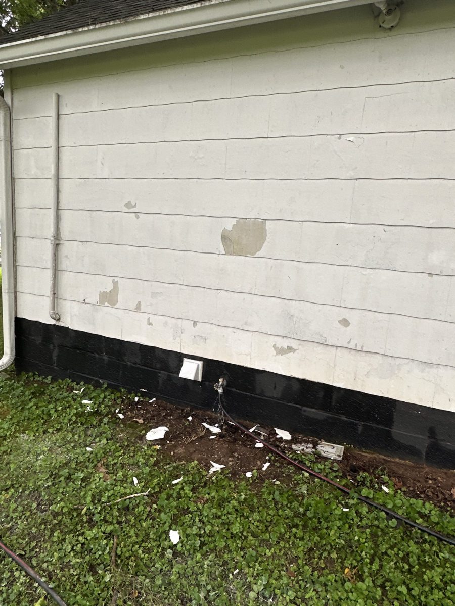 side of house with damaged white siding and black shutters Preview Image 17