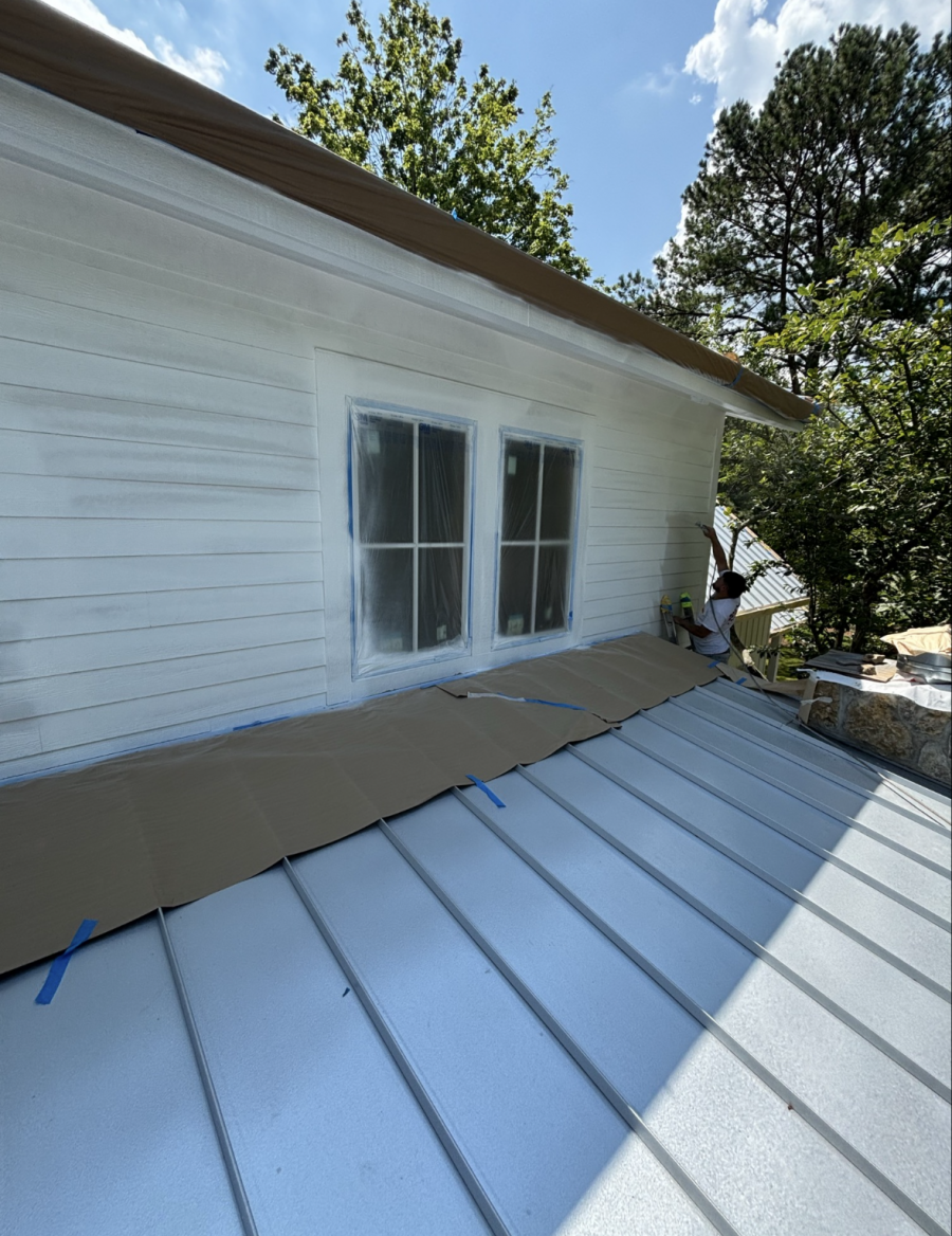 painter on a ladder painting siding on house Preview Image 5