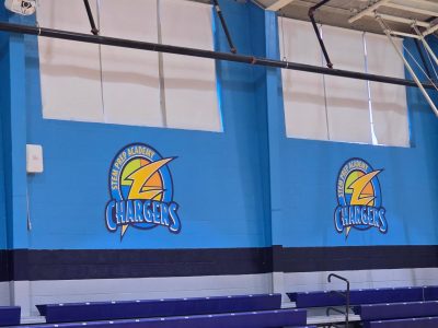 school gym with custom blue wall and lettering and logo