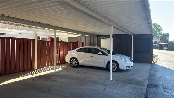 stained wood fencing surrounding covered parking area Preview Image 2