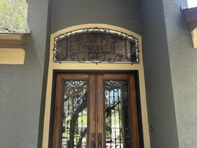 stained wooden door with painted metal accents