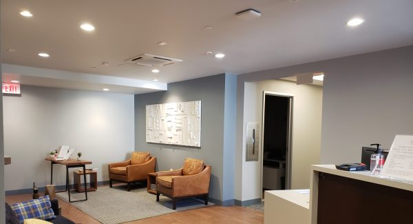 doctor's office lobby painting with hardwood floors and gray walls in Needham