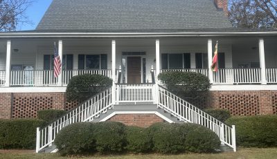 front exterior of house with porch and double staircase