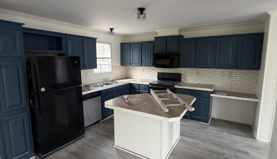 repainted kitchen with navy cabinets