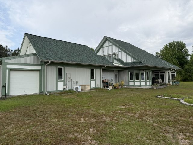 home exterior painted light sage green with darker green trim and accent areas Preview Image 2
