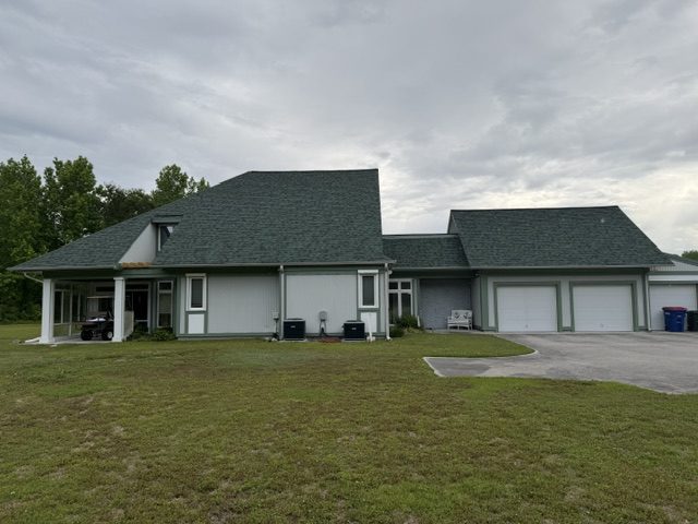home exterior painted light sage green with darker green trim and accent areas Preview Image 5