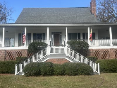 front exterior of house with porch and double staircase