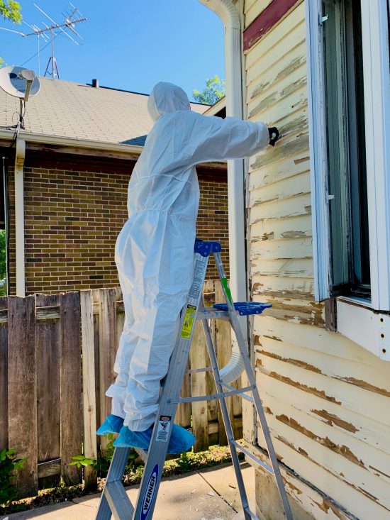 painter working on house with lead paint