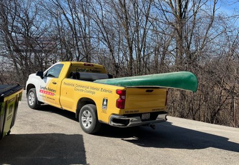 unpainted canoe in back of truck