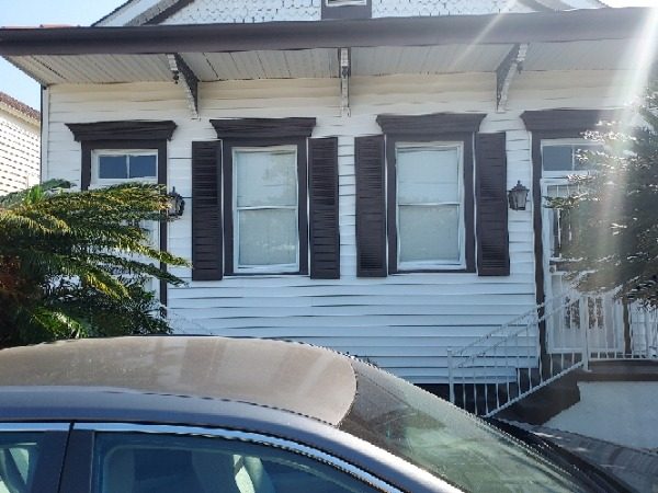 house with white siding and dark shutters on windows Preview Image 11