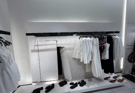 clothing store display with damaged drywall