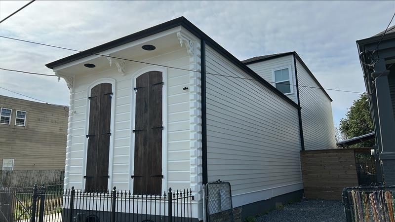 side of house with white painted siding and wooden shuttered windows Preview Image 4