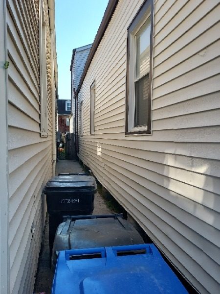 wheeled trash bins in walkway between two homes Preview Image 14