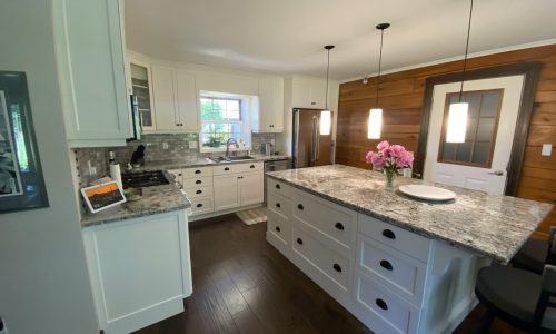 White Kitchen Cabinets w/ Wooden Backsplash
