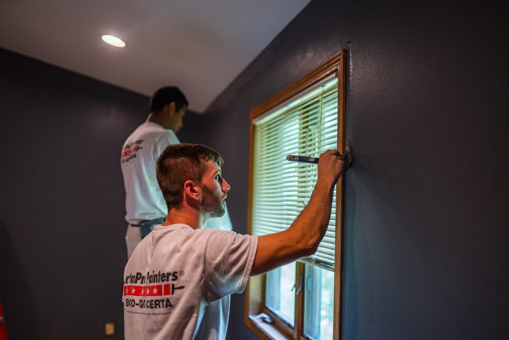 CertaPro painter painting a bedroom in North Charlotte, NC