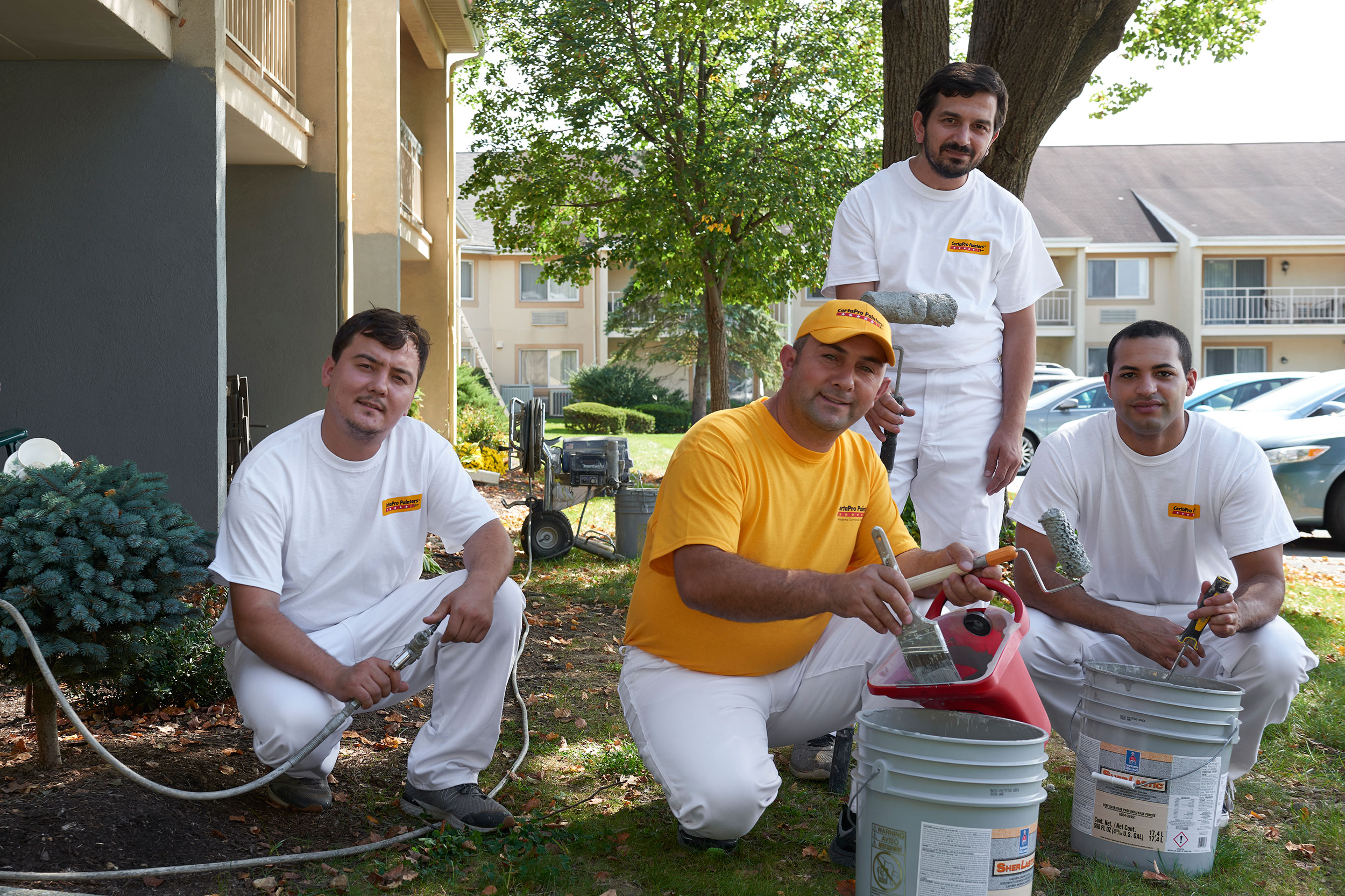 A group of CertaPro painters preparing to paint a condominium complex.