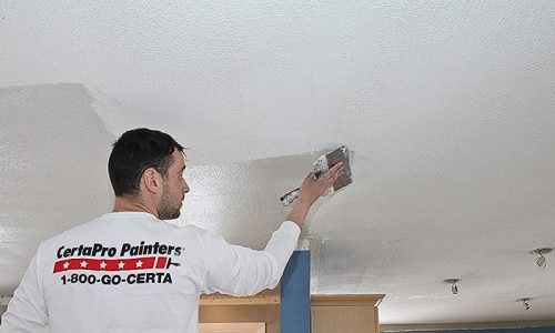 Popcorn ceiling removal services preparing the ceiling from a different view