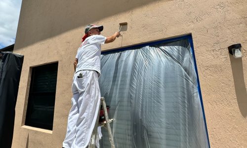 Miami painters on the job photo of man painting side of building while on ladder