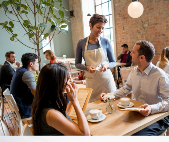 waitress in restaurant serving couple