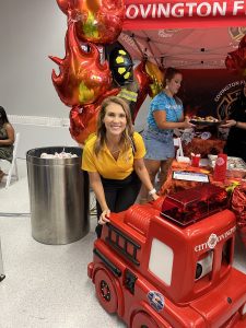 amanda in front of red firetruck toy