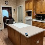 kitchen cabinet with island before being repainted